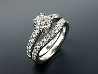 Round Brilliant 0.90ct D SI1 in an 8 Claw Platinum Setting with Round Brilliant Diamonds Claw Set into Band with Claw Set Fitted Wedding Ring.