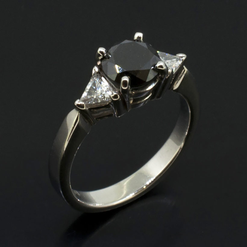 Round Black Diamond 1.14ct with Trilliant Cut Side Diamonds 0.30ct Total in a Palladium Claw Set Trilogy Design Ladies Ring