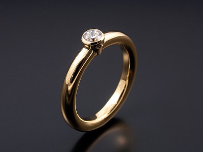 Round Brilliant 0.30ct F VS1 in an 18kt Yellow Gold Rub Over Setting with a Halo Band.