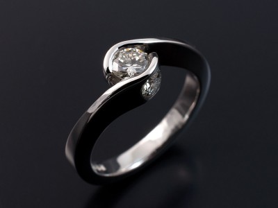 Round Brilliant 0.35ct H Colour VS2 Clarity in a Semi Tension Twist Platinum Setting with 2 x 0.15ct F VS Round Brilliant Diamonds Secret Set into Side of Setting.