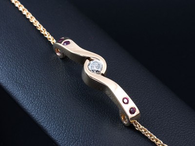 9kt Yellow Gold Secret and Tension Set Ruby and Diamond Twist Design Bracelet, Round Brilliant Cut 0.40ct F Colour VS2 Clarity and 4x Rubies