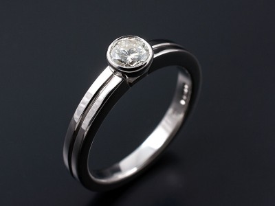 Round Brilliant 0.46ct H SI1 in an 18kt White Gold Rub Over Setting with Grooved Band.