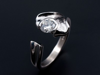 Round Brilliant 0.60ct E Colour SI1 Clarity in a Leaf Inspired Semi Rub Over Setting.