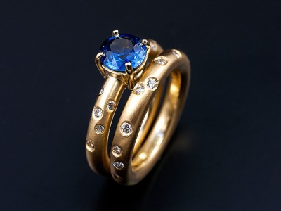 Round Ceylonese Sapphire 1.17ct in an 18kt Yellow Gold Setting with Scattered Secret Set Diamonds with a Matching Wedding Ring