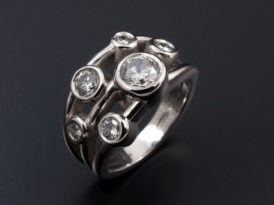 Satellite Design with Multiple Round Brilliant Diamonds in Palladium with Rub Over Settings.