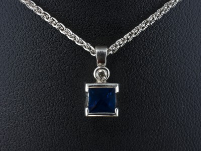 9kt White Gold Part Rub over Set Sapphire and Diamond Pendant, Princess Cut Sapphire 1.15ct and Round Brilliant Cut Diamond 0.04ct F Colour VS Clarity Min on a 9kt White Gold Spiga Chain