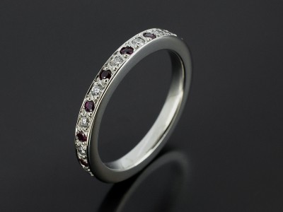 Ladies Diamond and Ruby Platinum Pave Set Wedding Ring.