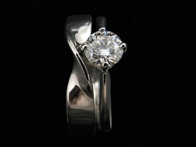 Platinum NSEW Engagement Ring with a 0.52ct F VS2 Round Brilliant Diamond with an Integrated Twisted Wedding Ring.