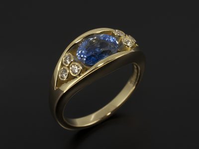 18kt Yellow Gold Tension Set Oval Sapphire 2.09ct & Rub-over Set Round Brilliant Cut Diamond 0.12ct (6) Ring Design