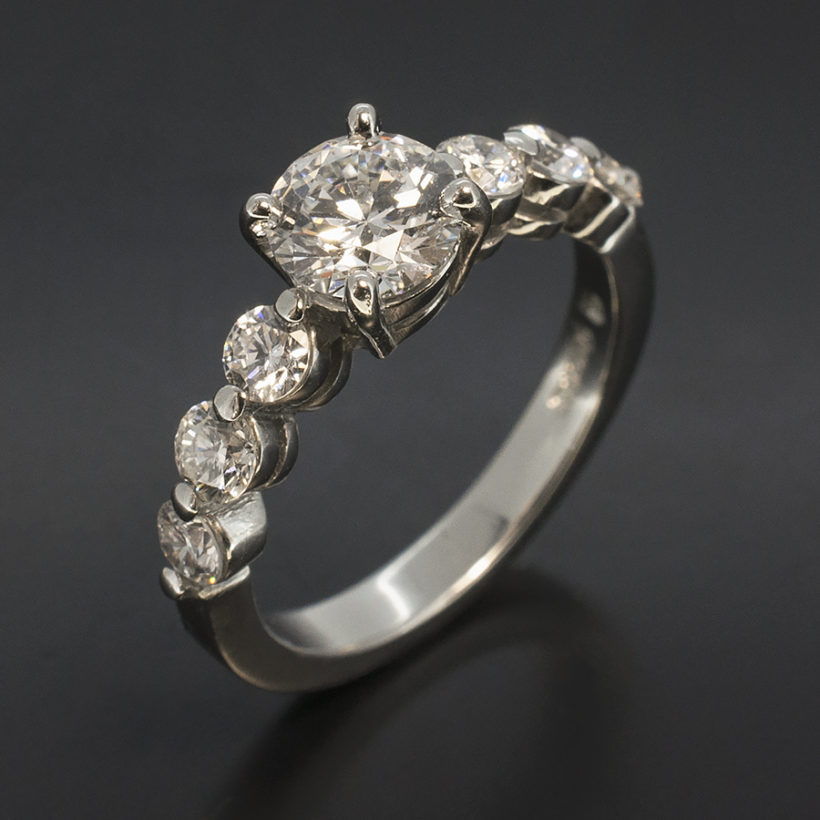 Round Brilliant Cut 0.71ct E Colour SI1 Clarity EXEXEX with 0.60ct Total F VS Round Brilliant Cut Diamonds in a Platinum 4 Claw and Shared Claw Set Design Engagement Ring