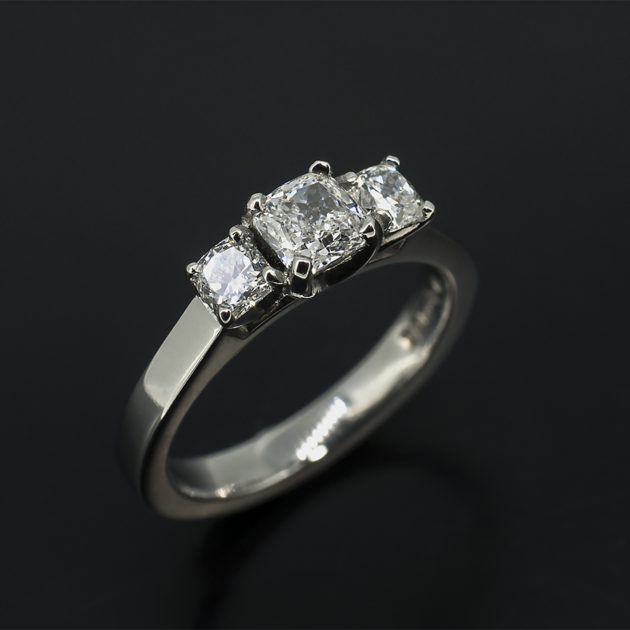 Cushion Cut 0.51ct D Colour VS2 Clarity EXVG with Cushion Cut Side Diamonds 0.40ct Total in a Platinum Claw Set Trilogy Design Engagement Ring
