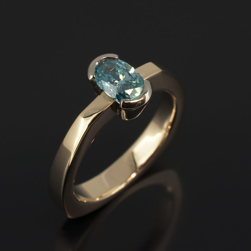 9kt Rose and White Gold Half Rub Over Set Contemporary Design Ladies Ring with Oval Blue Treated Diamond 0.66ct