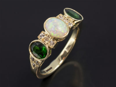 Ladies Diamond and Coloured Stone Dress Ring, 18kt Yellow Gold Rub over and Claw Set Design, Cabochon Cut Opal 0.63ct Centre Stone, Oval Cut Tsavorites 1.21ct (2), Round Brilliant Cut Diamonds 0.32ct (12)