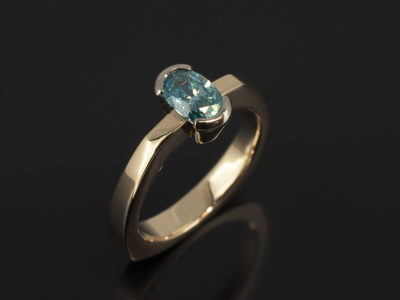 9kt Rose and White Gold Half Rub Over Set Geometric Design with Oval Cut Blue Treated Diamond 0.66ct