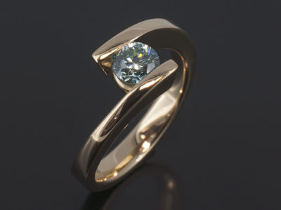 9kt Yellow Gold Tension Set Twist Design Round Brilliant Cut Blue Diamond 0.62ct