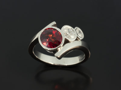 Blood Orange Sapphire 2.64ct with Oval Cut Diamonds 0.32 and 0.13ct F Colour VS Clarity in a Platinum Rub Over Set Twist Band Design