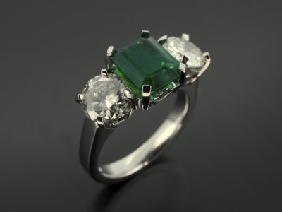 Emerald 1.77ct with Round Brilliant Cut Diamonds 1.03ct and 0.89ct F SI in a Platinum 4 Claw Trilogy design with Leaf Detail