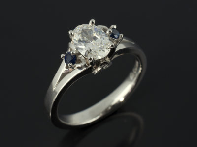 Oval Cut Diamond 0.71ct F Colour SI2 Platinum Design with Round Brilliant Cut Sapphires Triquetral