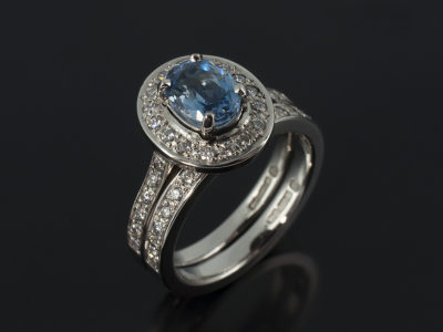 Ladies Engagement Ring with Oval Cut Aquamarine 0.7ct in Palladium Halo alongside fitted Wedding Ring