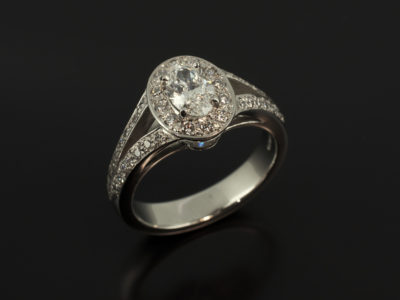 Ladies Diamond Engagement Ring, Platinum Claw and Pavé Set Halo Design, Oval Cut Diamond 0.51ct, F Colour, VS2 Clarity, Round Brilliant Cut Diamond Halo and Shoulders 0.34ct Total, Split Band Detail
