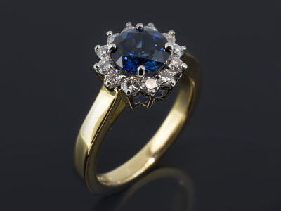 Platinum & 18kt Yellow Gold Cluster Design. Round Brilliant Cut Sapphire 1.35ct. Round Brilliant Cut Diamonds, 0.35ct (12)