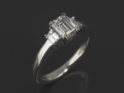 Ladies Trilogy Diamond Engagement Ring, Platinum Claw Set Design, Emerald Cut Diamond Centre Stone 1.00ct, E Colour, VS2 Clarity, Trapezium Cut Diamond Side Stones 0.43ct (2), F Colour, VS Clarity