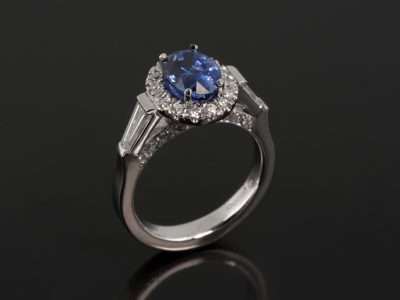 Platinum Claw and Castle Set with Oval Sapphire 1.55ct, Tapered Baguettes 0.39ct and Round Brilliant Cut Diamonds 0.26ct