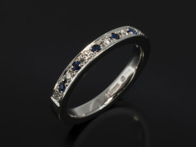 Platinum Pavè Round Brilliant Cut Diamond, 0.10ct (7), F Colour, SI Clarity Minimum. Round Brilliant Cut Sapphire, 0.12ct