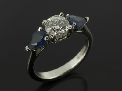 Round Brilliant Cut Diamond 0.62ct D Colour SI1 EXEXEX with 0.90ct Total Sapphire Pear Cut in Claw Set Palladium Design