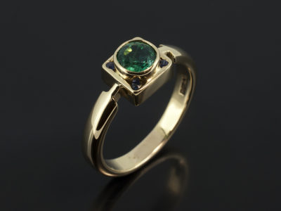 Round Emerald 6mm with Round Sapphires 4 x 1.5mm in a 18kt Yellow Gold Rub Over Contemporary Design