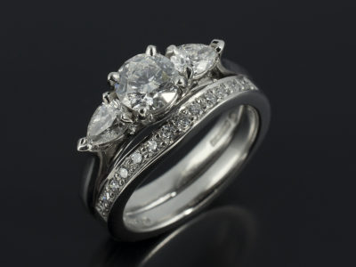Round Brilliant Cut Diamond with Pear Shape Side Diamonds with Pavè Set Matching Ring