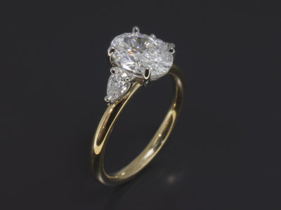 Ladies Trilogy Diamond Engagement Ring, Platinum and 18kt Yellow Gold Claw Set Design, Oval Cut Diamond 1.20ct, E Colour, VVS2 Clarity, Pear Cut Diamond Side Stones 0.21ct (2), F Colour, VS Clarity Minimum
