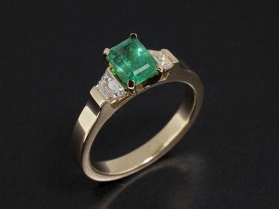 18kt Yellow Gold Trilogy Design wih Emerald Cut Emerald 1.06ct and Trapezium Cut Side Diamonds 0.37ct Total