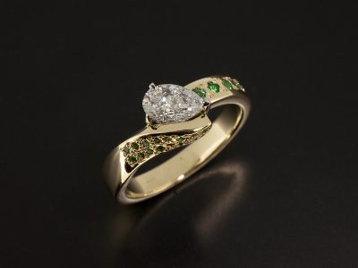 18kt Yellow Gold and Platinum Claw Set Twist Band Design with Pear Cut Lab Grown Diamond 0.66ct E VS2 VGVG and Pave set Round Brilliant Cut Emeralds x 23