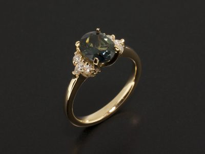 Oval Cut Green Sapphire 1.36ct with side Marquise and Round Brilliant Cut Diamonds in an 18kt Yellow Gold Claw Setting