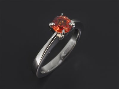 Platinum Four Claw Set Solitaire Design. Round Brilliant Cut Orange Sapphire, 0.73ct.