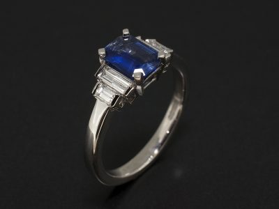 Emerald Cut Sapphire 0.89ct with Baguette Cut Diamonds 0.46ct Total in a Platinum Claw and Tension Set Design