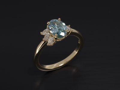 Oval Blue Diamond 0.89ct wih Pear Cut Diamonds 0.16ct Total and Round Brilliant Cut Diamond 0.05ct in a Claw Set 18kt Yellow Gold Design