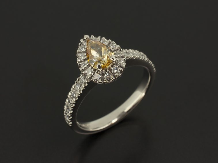 Pear Cut Fancy Yellow Diamond 0.60ct with Claw Set Diamond Halo and Shoulders 0.39ct Total in a Platinum Design
