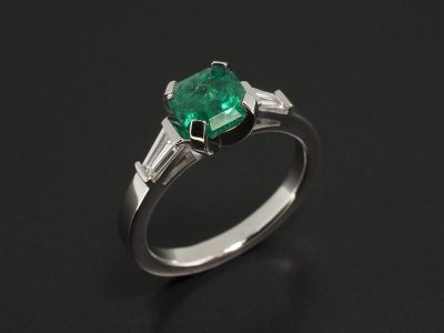 Platinum Claw Set Trilogy Design with Asscher Cut Emerald 1.16ct and Tapered Baguettes 0.37ct Total