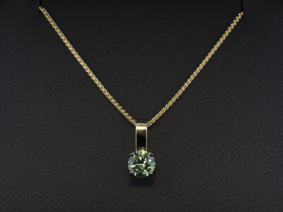 18kt Yellow and White Gold Claw Set Solitaire Coloured Diamond Pendant, Round Brilliant Cut Treated Green Diamond 0.77ct