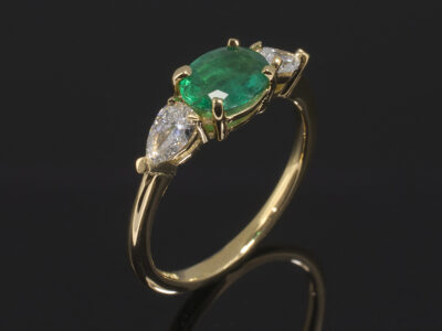 18kt Yellow Gold Claw Set Design. Oval Cut Emerald 0.61ct 7x5mm. Pear Cut Diamonds, approx 0.20ct (2). F Colour SI Clarity Minimum