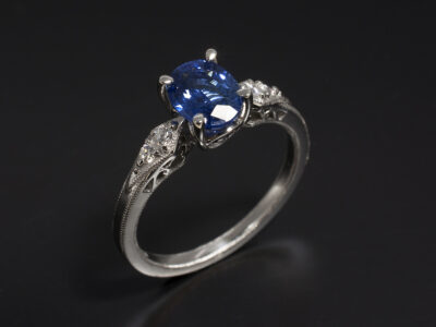 Ladies Sapphire and Diamond Ring, Platinum Claw and Pavé Set Design, Oval Cut Sapphire 1.26ct, Round Brilliant Cut Diamonds 0.06ct with Antique Millgrain Detail