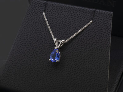 9kt White Gold Claw Set Tanzanite Pendant, Pear Cut Tanzanite 1.25ct, Double Bale Detail on a Spiga Chain