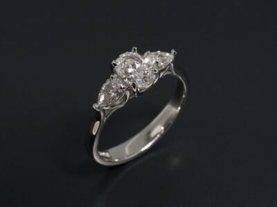 Ladies Trilogy Diamond Engagement Ring, Platinum Claw Set Design, Oval Cut Diamond 0.70ct, E Colour, SI1 Clarity, Pear Cut Diamond Side Stones 0.36ct Total