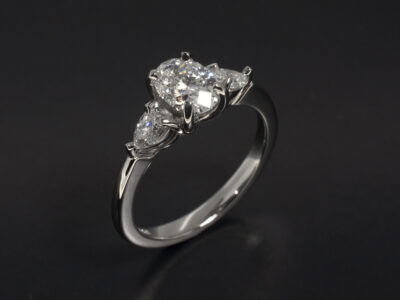 Ladies Trilogy Diamond Engagement Ring, Platinum Claw Set Design, Oval Cut Lab Grown Diamond, 1.00ct, D Colour, SI1 Clarity, Pear Cut Diamond Side Stones, 0.37ct Total