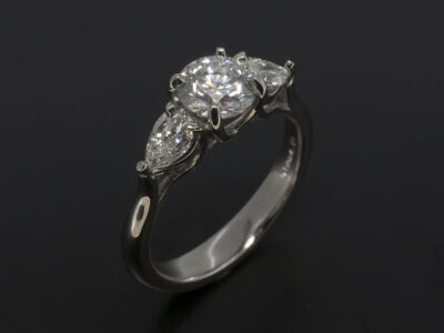 Ladies Trilogy Diamond Engagement Ring, Platinum Claw Set Design, Round Brilliant Cut Diamond 0.77ct, E Colour, SI Clarity, EXEXEX, Pear Cut Diamond Side Stones 0.49ct (2), F Colour, SI Clarity Minimum
