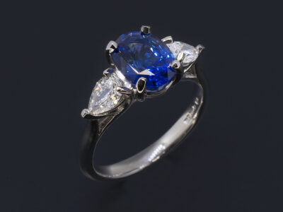 Ladies Trilogy Sapphire and Diamond Ring, Platinum Claw Set Design, Oval Cut Blue Sapphire 1.80ct, Pear Shaped Diamonds 0.53ct (2), F Colour, VS Clarity Minimum