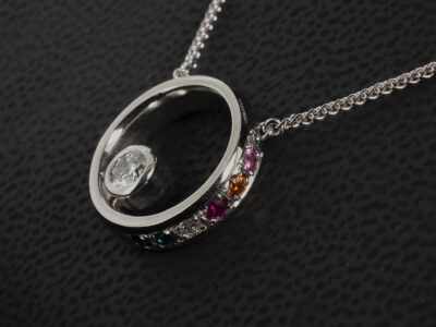 Palladium Rub over and Pavé Set Diamond and Coloured Stone Pendant, Round Brilliant Cut Solitaire Diamond Rests in Round Cut Coloured Stone Set Halo