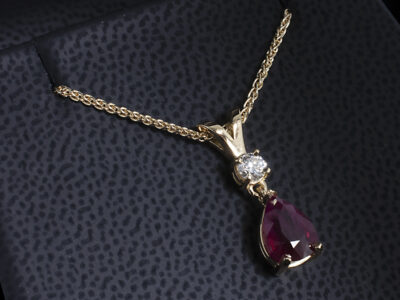18kt White Gold Part Rub over Set Diamond and Ruby Drop Pendant, Pear Cut Ruby 1.47ct, Round Brilliant Cut Diamond 0.15ct, F Colour, VS Clarity, Double Bale Detail
